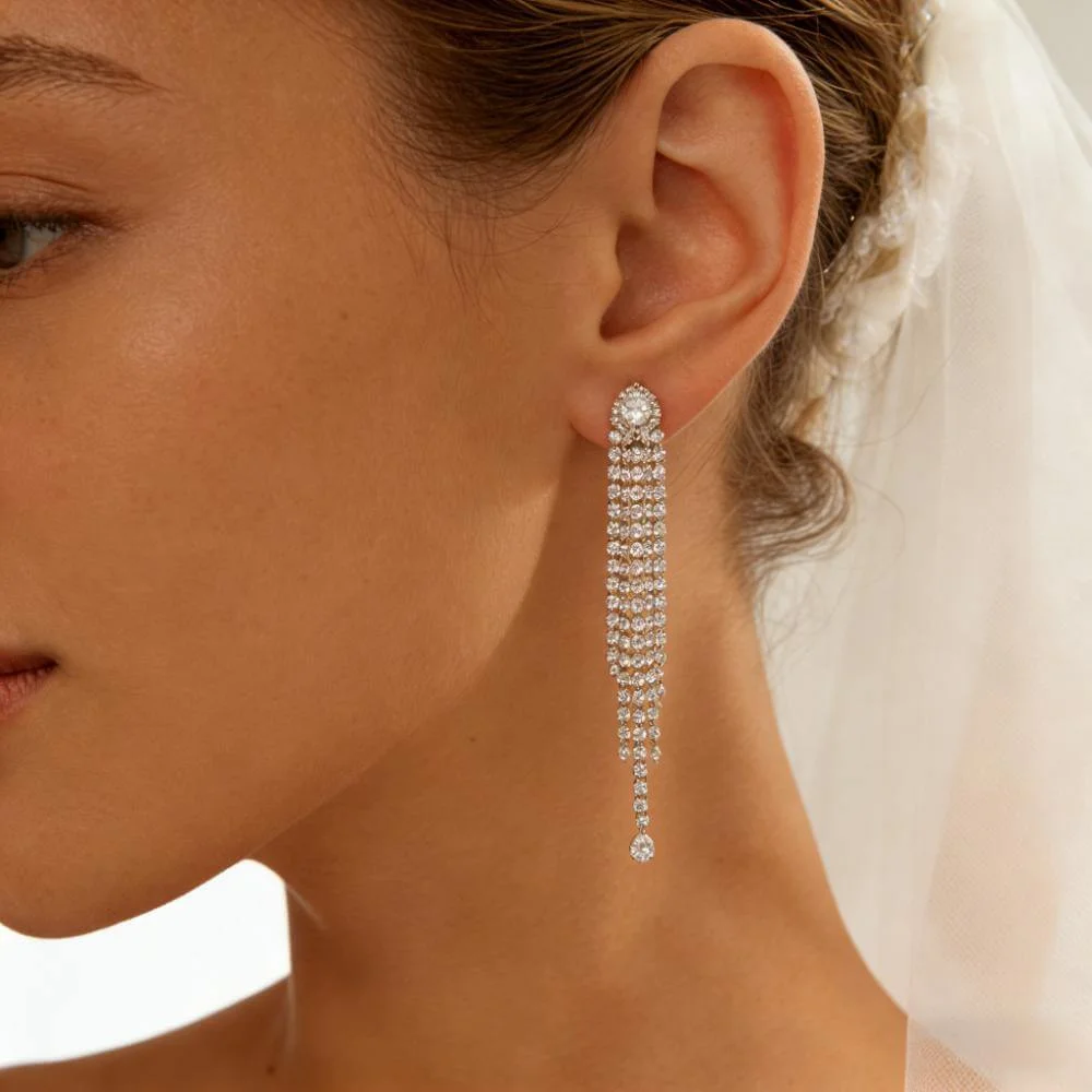 Editorial bridal detail shot with hair up, model wearing bridal earrings in bright classic styling.