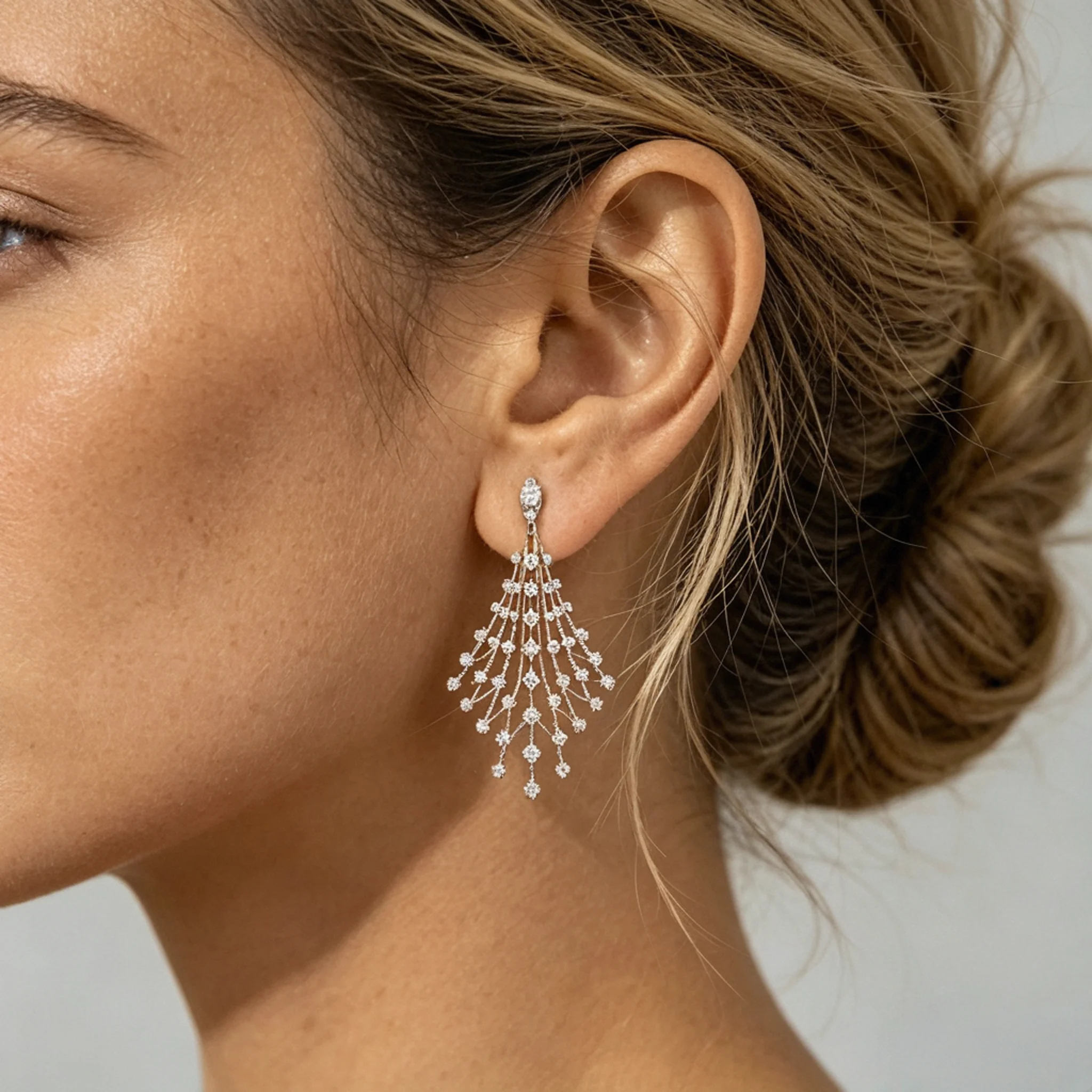 Diamond chandelier earrings styled with layered drops and formal evening presence