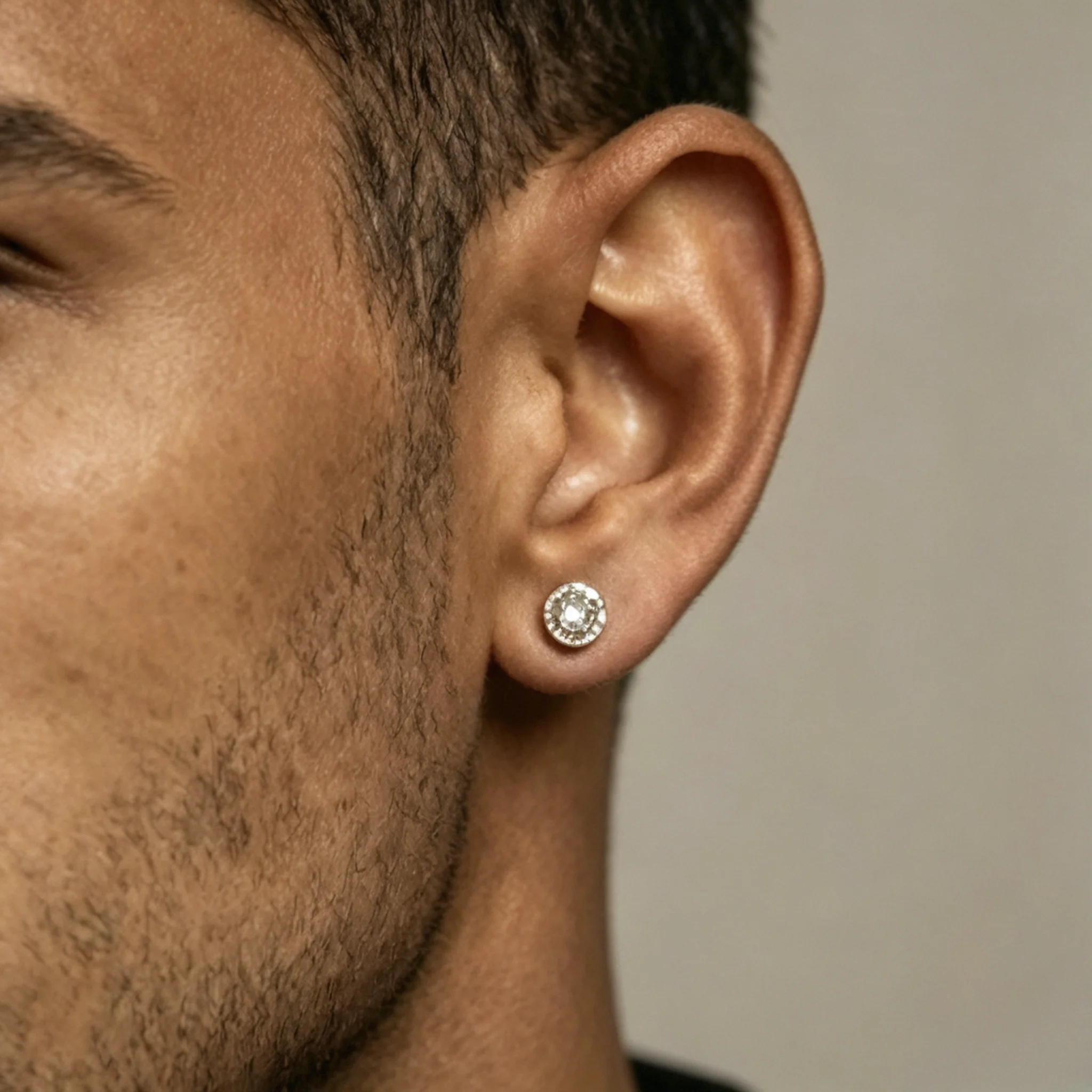 Diamond stud earrings shown on a model with clear stone size and lobe proportion