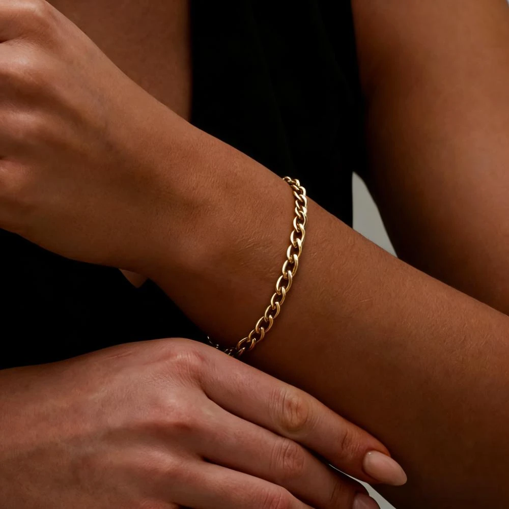 Gold bracelet on a model’s wrist generated by AI.