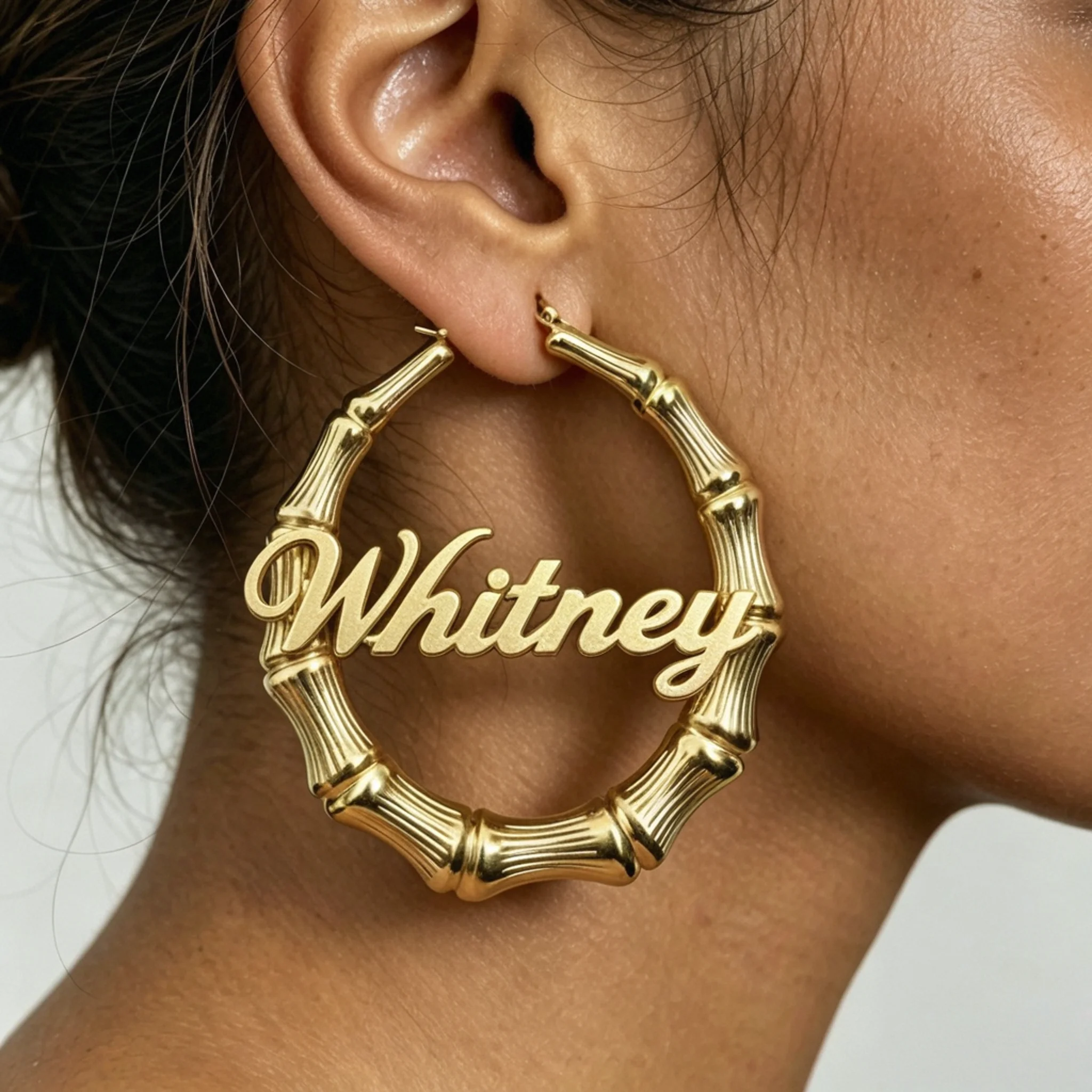nameplate bamboo earrings on a model with readable lettering