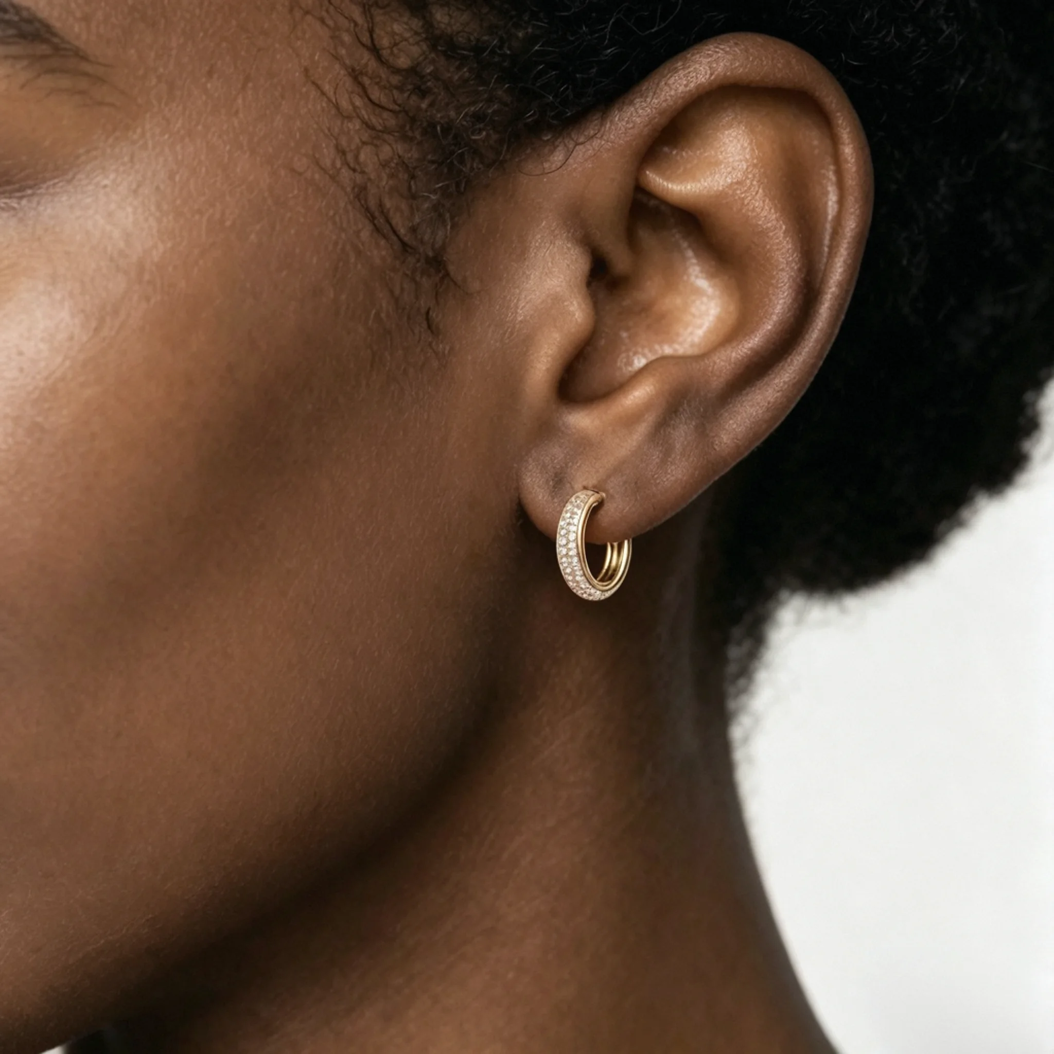 Pavé diamond earrings shown on a model with close detail, shine, and ear placement