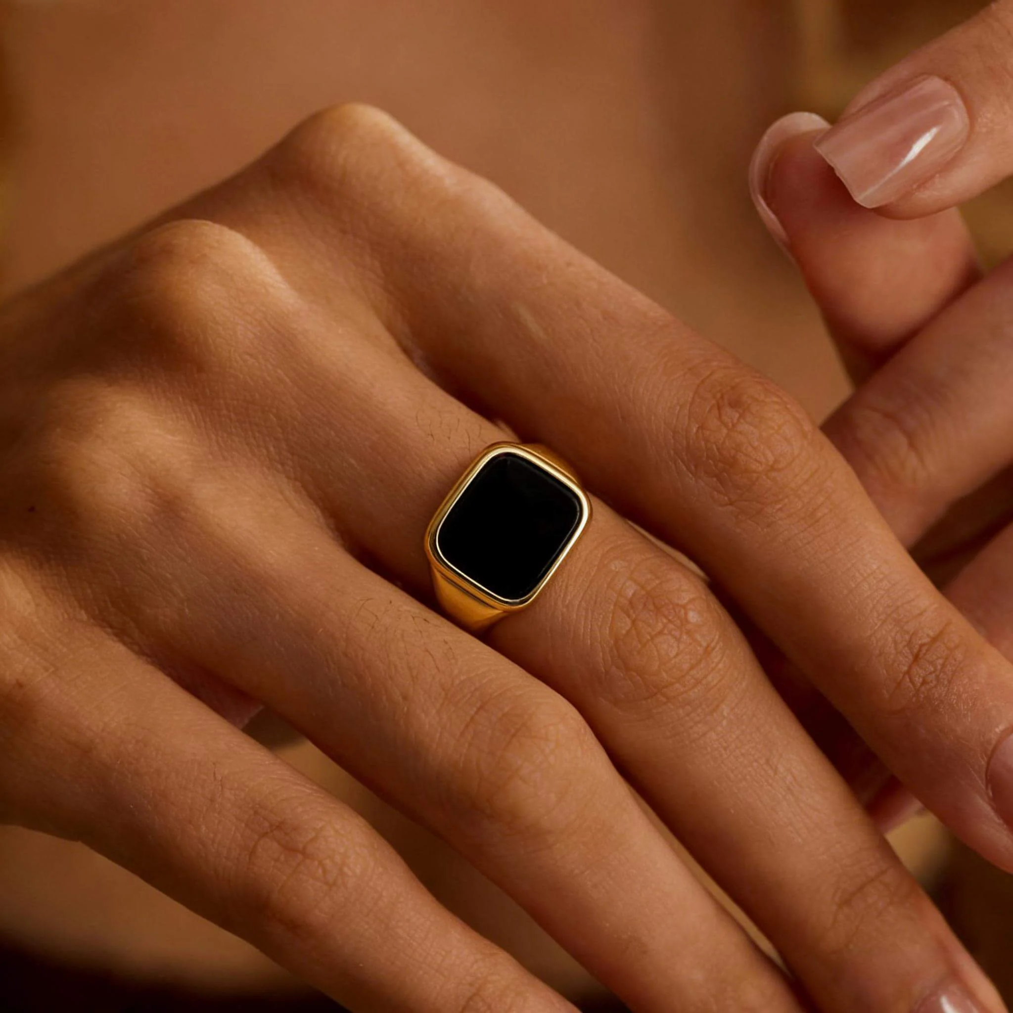 Signet ring on-hand set with a readable face-forward hero, engraving close-up, thickness angle, and presence reference