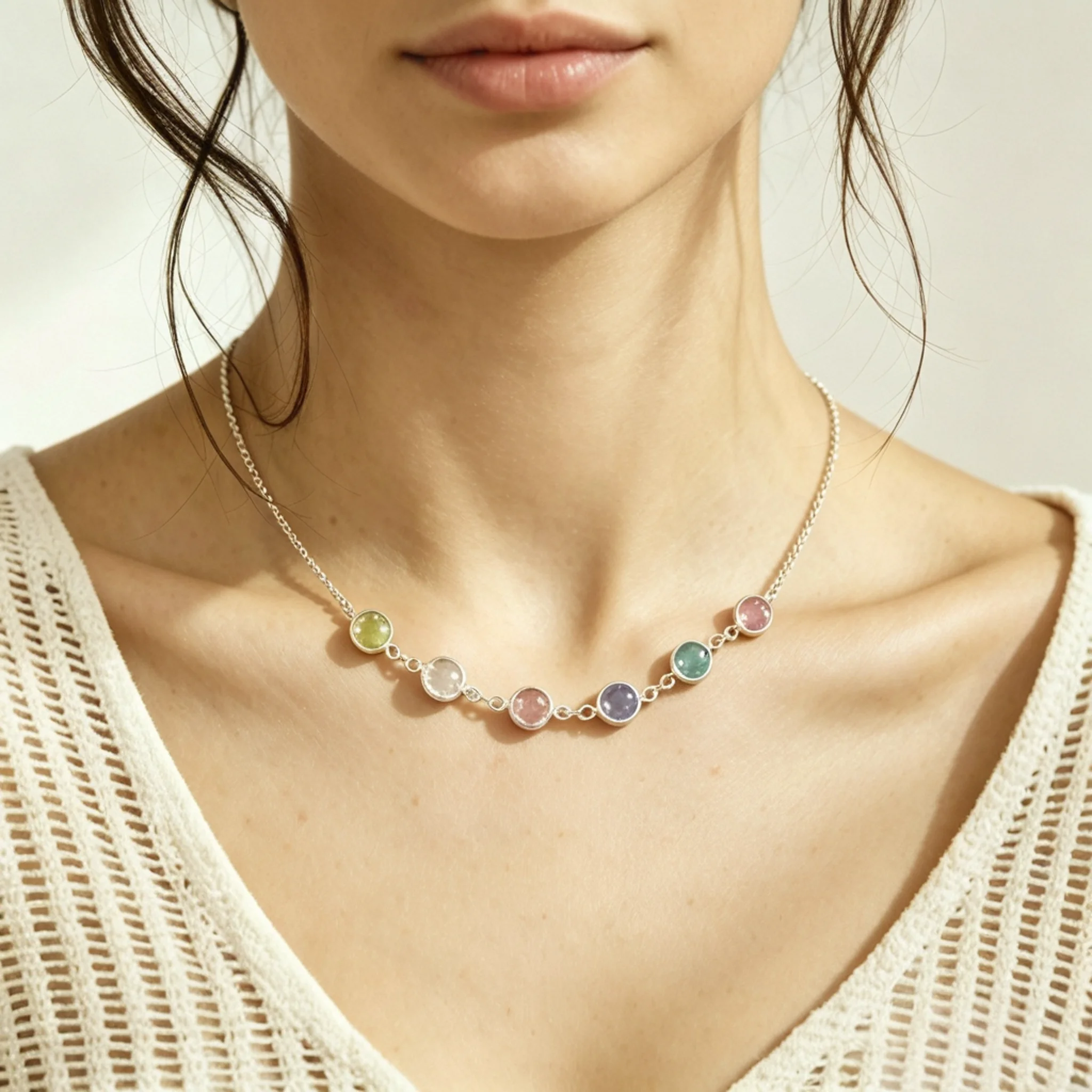 Silver birthstone necklace shown on a model with visible gem color and natural pendant size