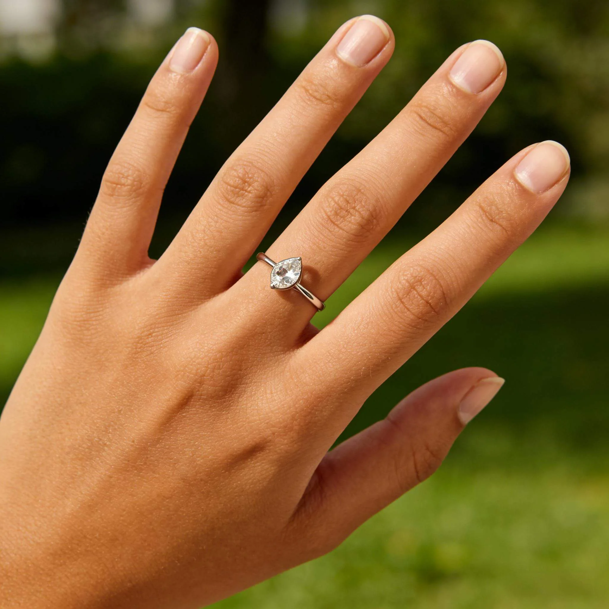 Solitaire ring on-hand set showing a minimal hero, prong close-up, profile height, and soft sparkle angle in clean lighting.